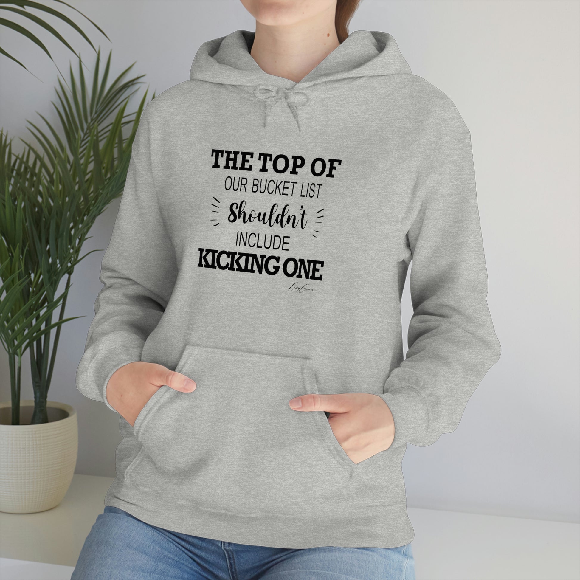 woman-wearing-hoodie-with-funny-quote-the-top-of-our-bucket-list-shouldn't-include-kicking-one