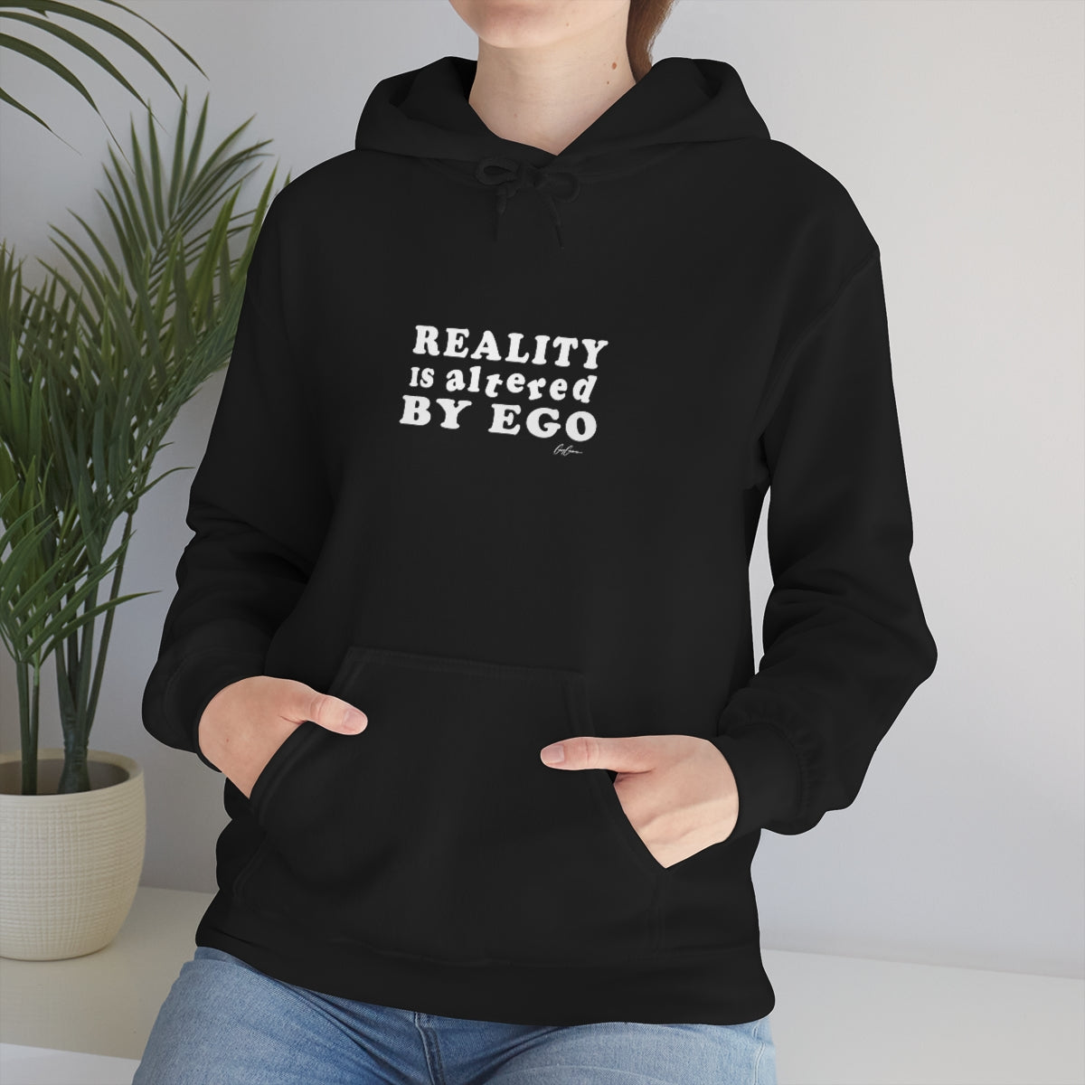 woman-wearing-hoodie-with-quote-reality-is-altered-by-ego